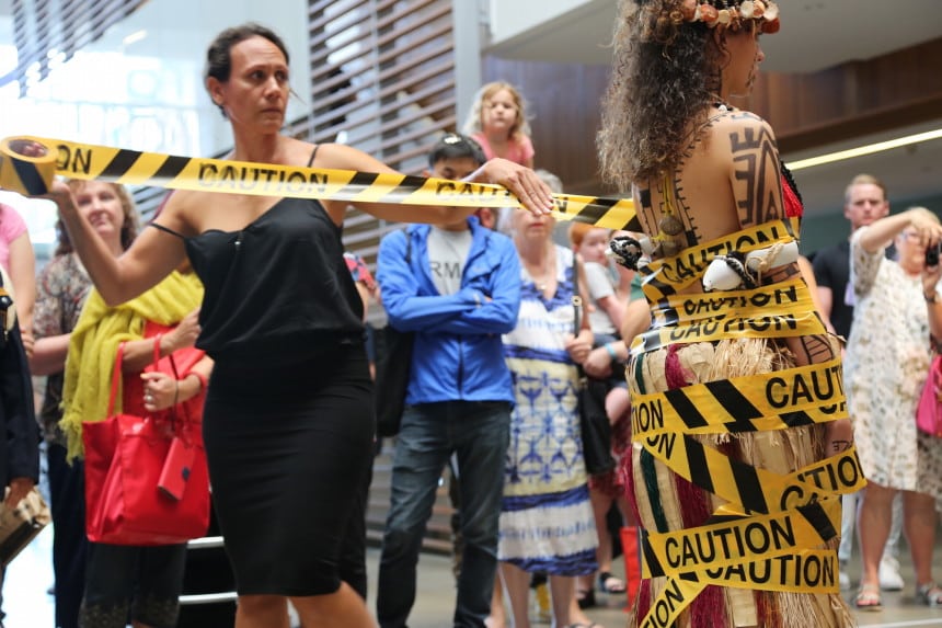 Julia Mageau-Gray wrapping “traditional, Papuan culture” in caution tape to signify the labels that are placed on our culture. 